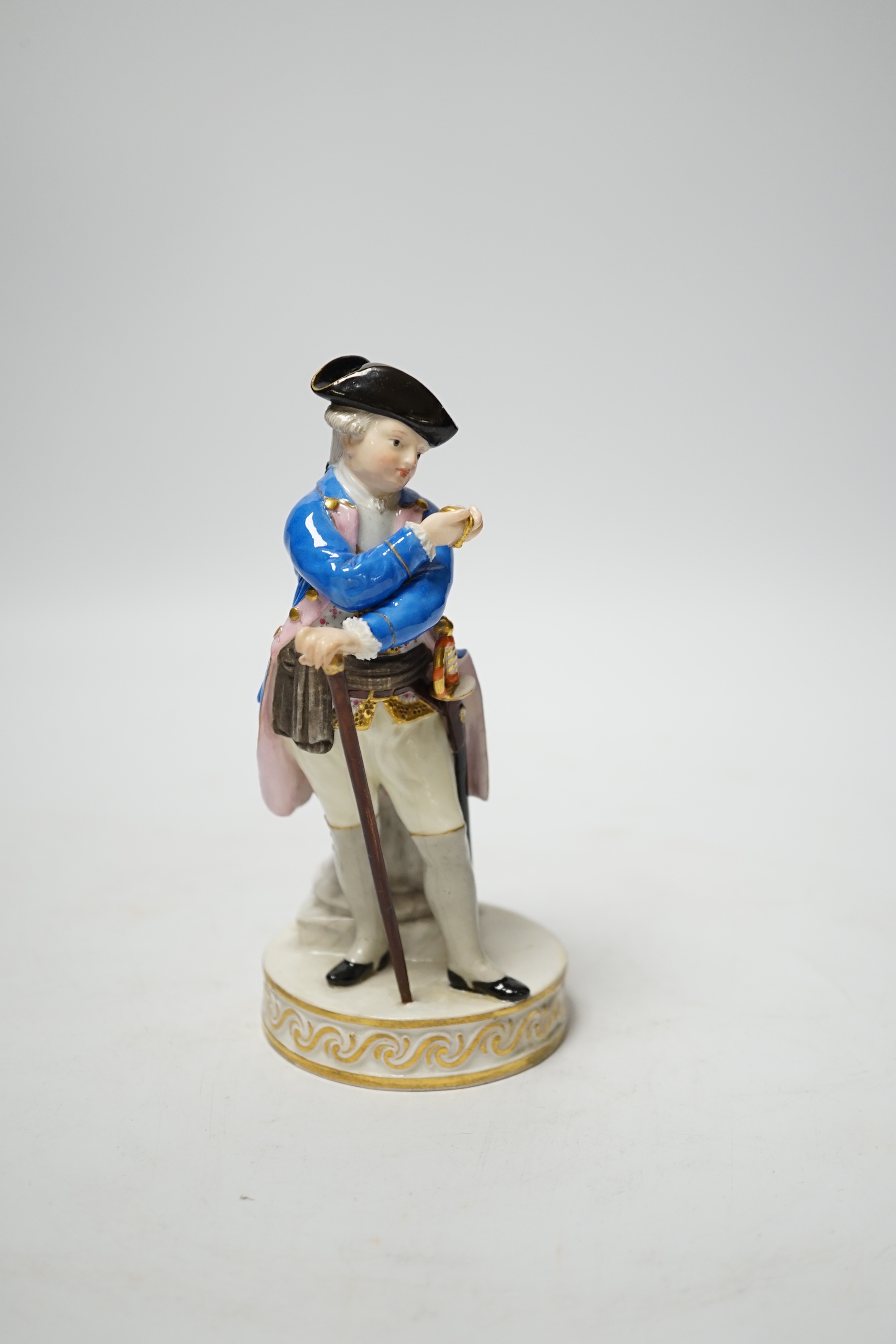 A late 19th century Meissen figure of an officer looking at his watch, incised F64 and impressed 122, 15cm